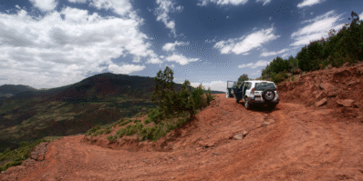 Rental car parked in scenic Moroccan landscape during a road trip adventure