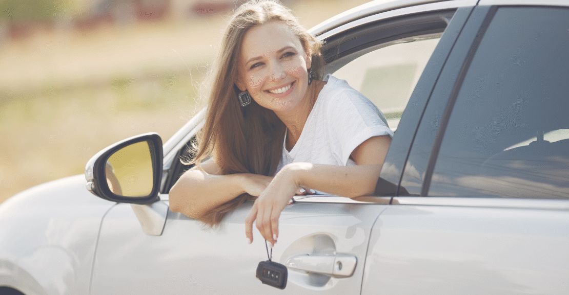 Smiling woman enjoying a scenic road trip in Morocco inside a rental car