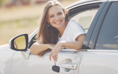 Smiling woman enjoying a scenic road trip in Morocco inside a rental car