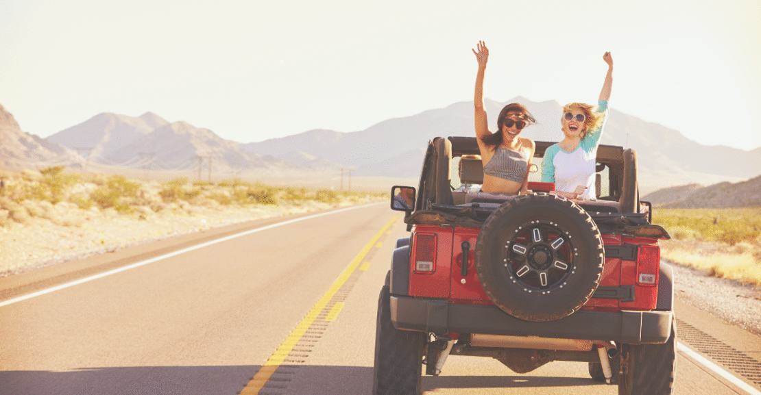 Two travelers enjoying a jeep ride through the Moroccan desert